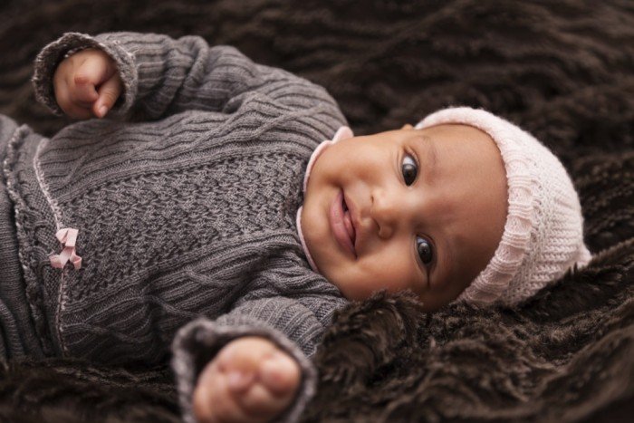 Beautiful baby girl in grey