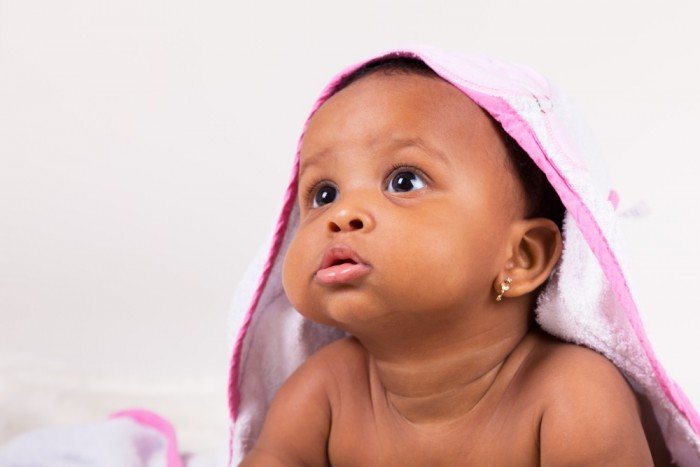Gorgeous baby girl under a towel