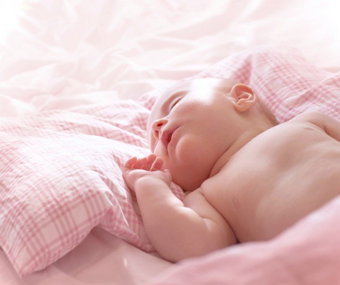 Little lady sleeping on pink plaid