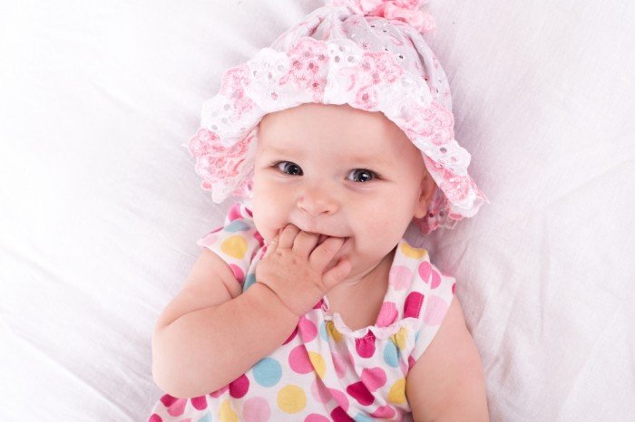 Smiling baby girl in a bubble top