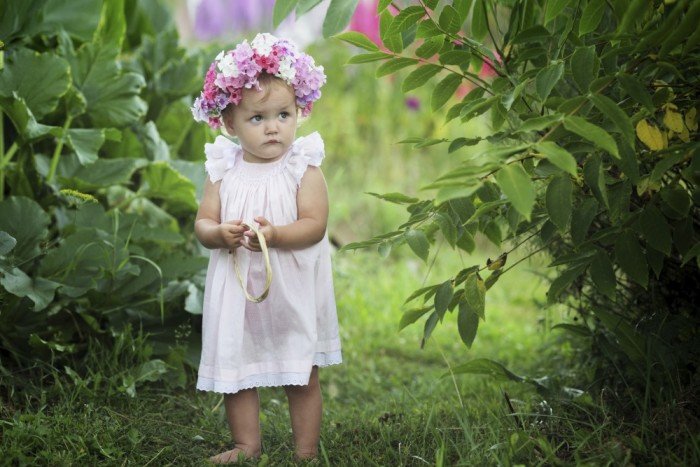 Toddler girl in in smocked dress and flower crown