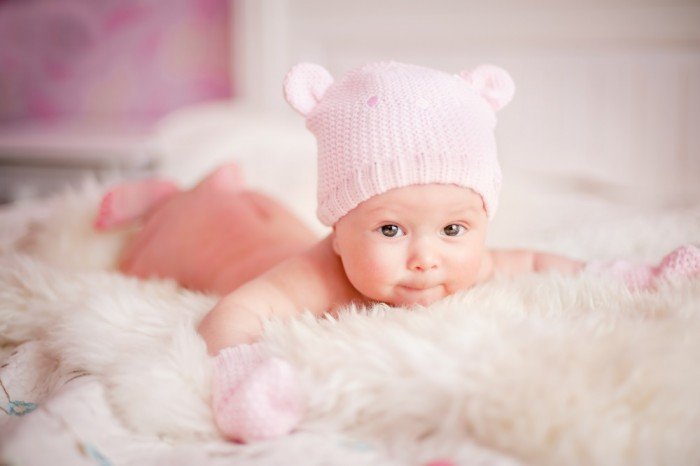 Sweet newborn girl with bear hat