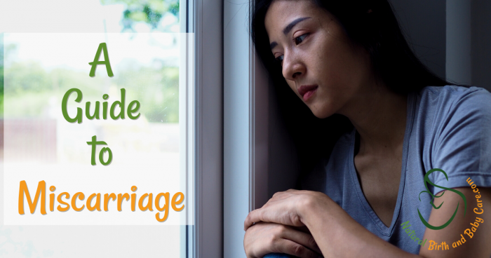 woman looking sadly out of a window