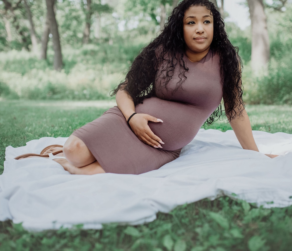 Gentle Birth No Tearing Class Pregnant mom sitting outside on soft blanket