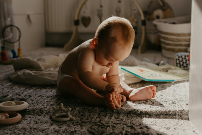 Big picture fertility Baby playing with his feet in sunlight